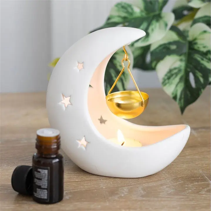 White crescent moon oil burner with a gold dish
