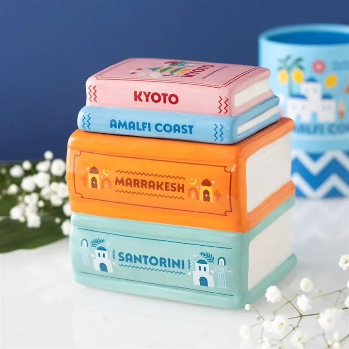 Ceramic oil burner shaped like a stack of travel books
