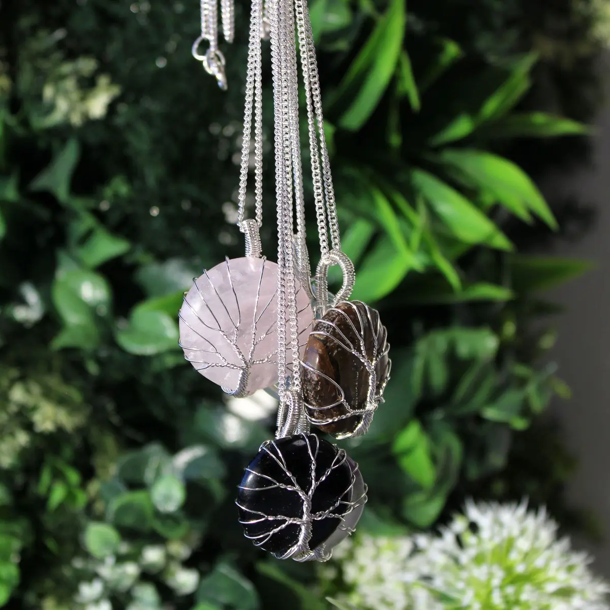 Rose quartz in a tree of life cage pendant